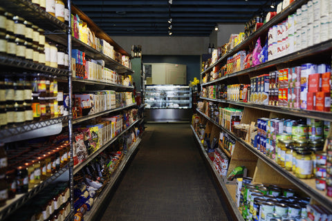 Specialty grocery aisle featuring gourmet foods, imported products, and pantry essentials.